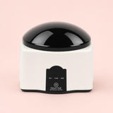Removedor de esmalte de gel por vapor Nailyx sobre fondo rosa